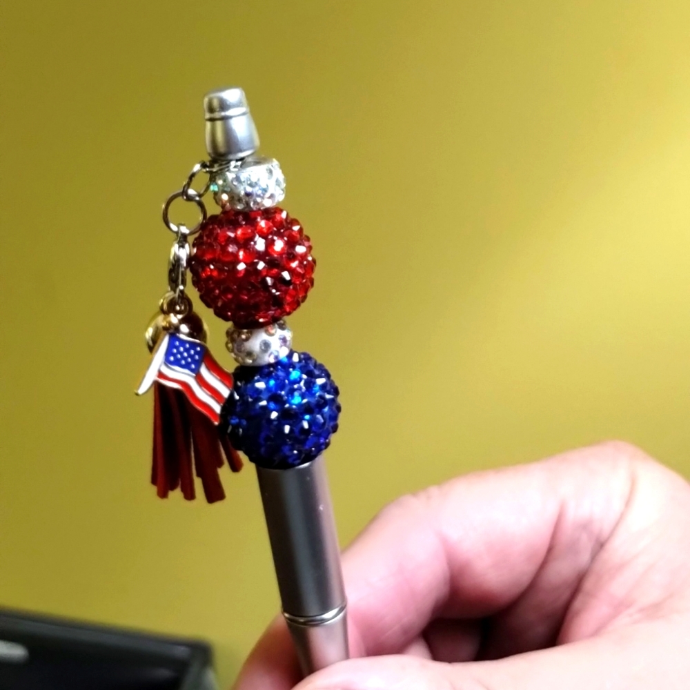 Silver red white and blue pen